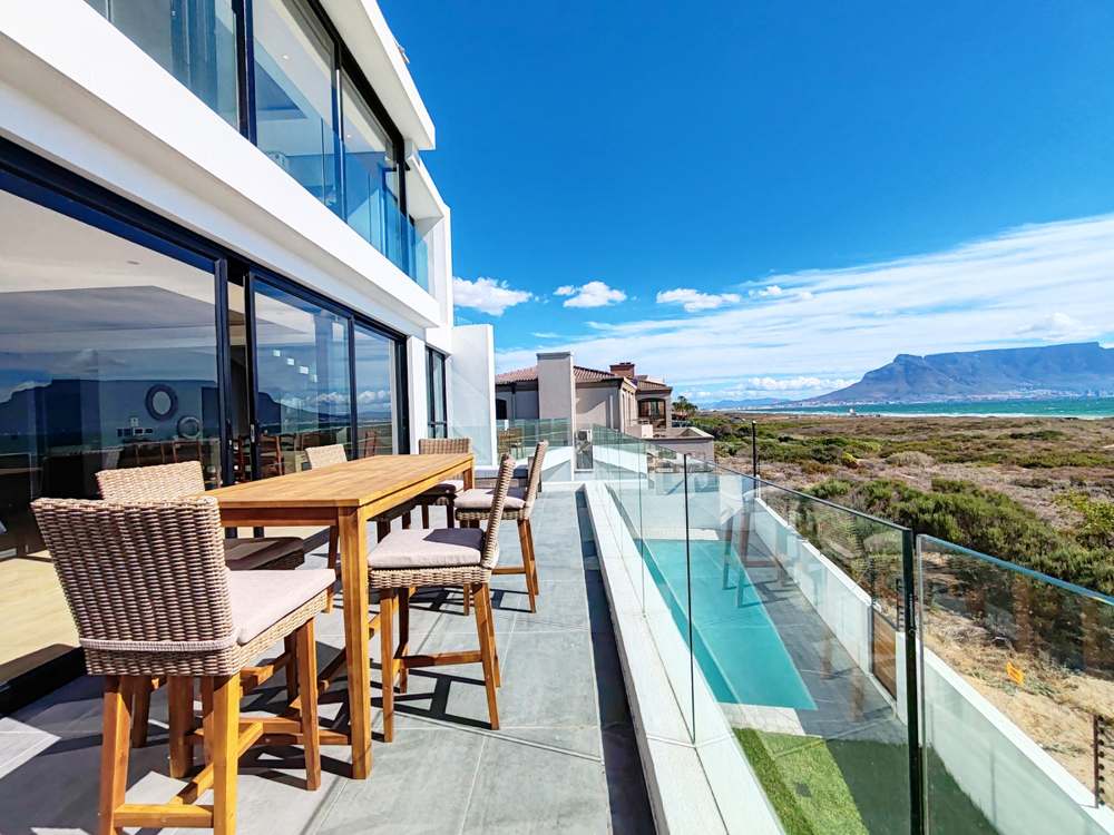 Roof terrace dining at Drift villa with Table Mountain views, Sunset Beach Cape Town