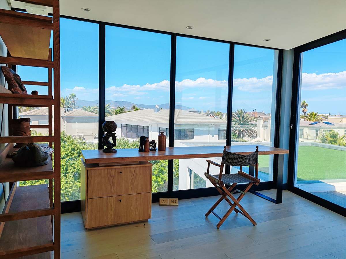 Open-plan interior with ocean light at Drift Sunset Beach House