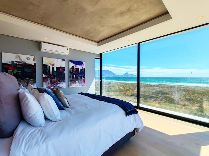 Panoramic Ocean Suite bedroom with sea views at Drift Sunset Beach House